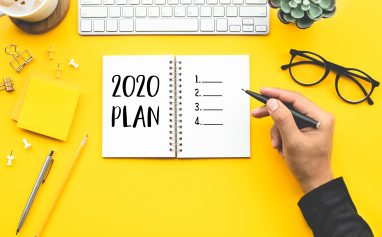 2020 plan concepts with youngman writing checklist on notepad on color desk table.Goal-plan-action and resolution concepts ideas